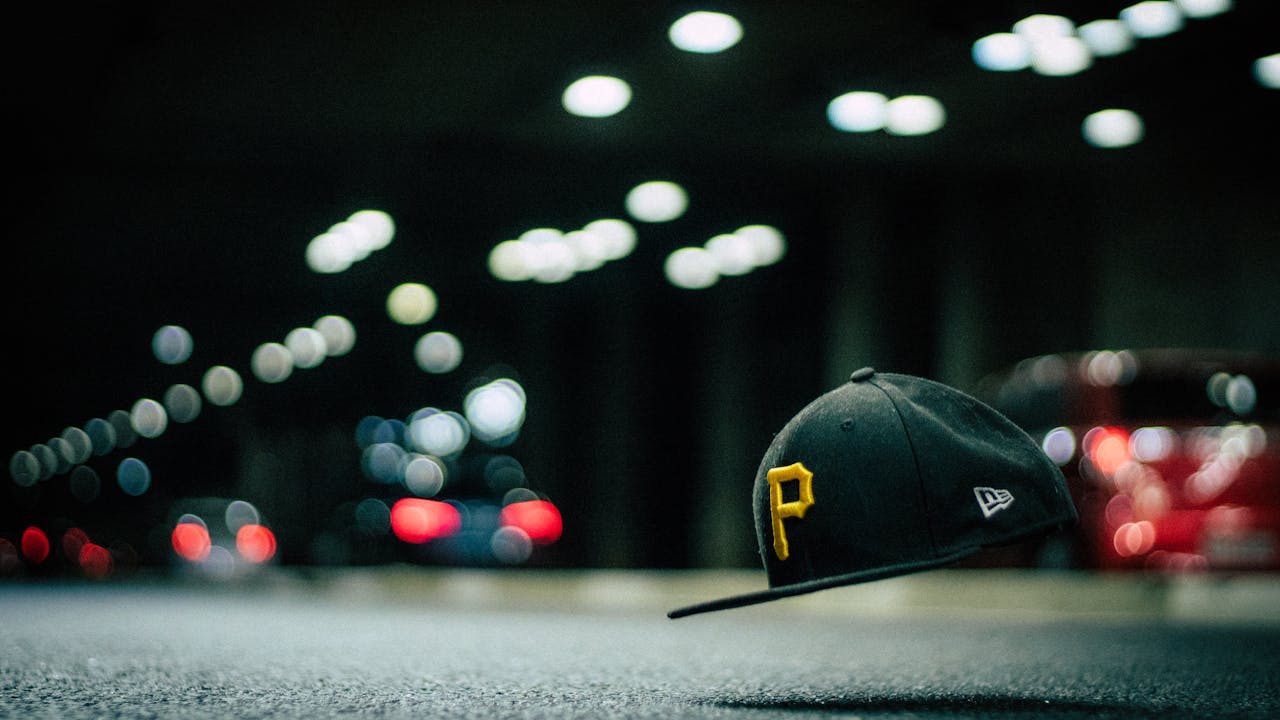 gallery-2 A levitating cap with letter 'P' floats above asphalt, surrounded by night street bokeh lights.